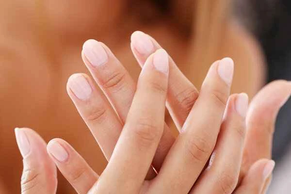 What causes fingernails to turn slightly black?